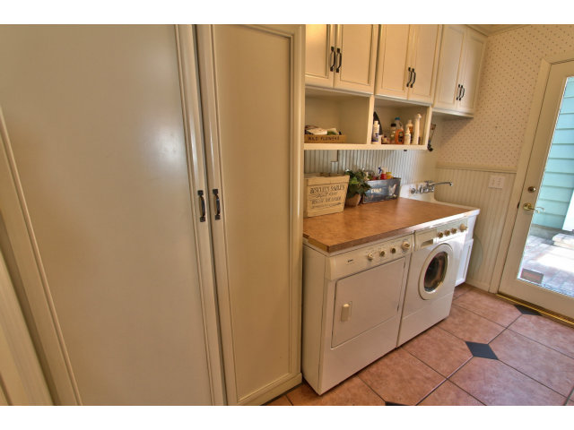 3055 Sloat Road Pebble Beach, CA 93953 - Photo 17 of 25 a utility room with cabinets washer and dryer