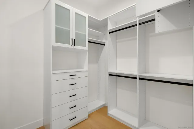 a view of walk in closet with empty racks