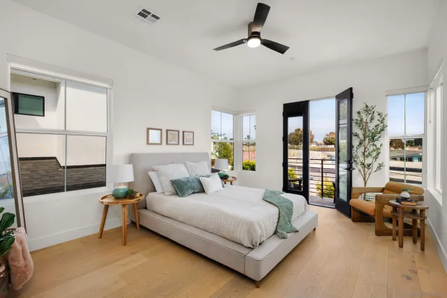 a bedroom with a bed couch and a view of living room