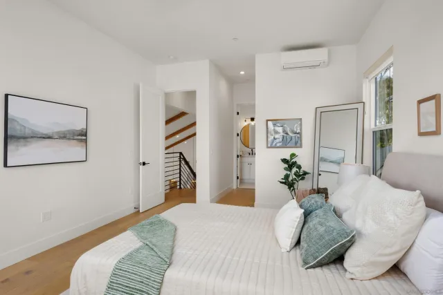 a bedroom with a bed and a painting on the wall