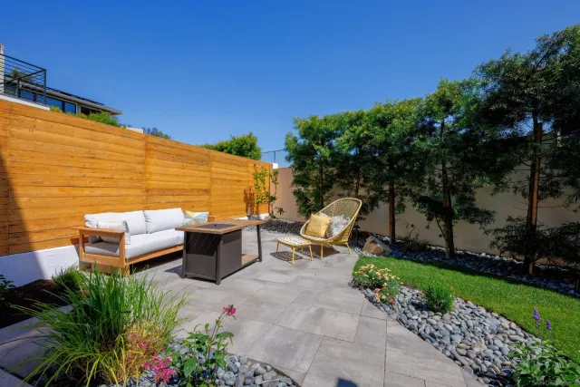 a backyard of a house with outdoor seating