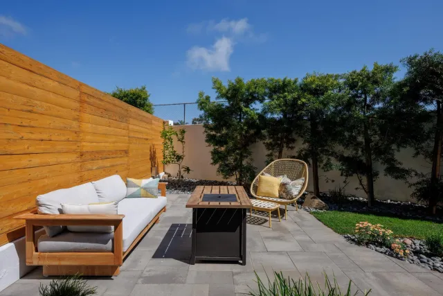 a view of a patio with a table and chairs under an umbrella