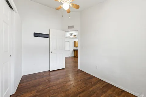 a view of empty room with wooden floor