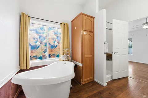 a white bath tub sitting next to a white toilet