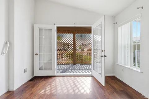 a view of a room with wooden floor and windows