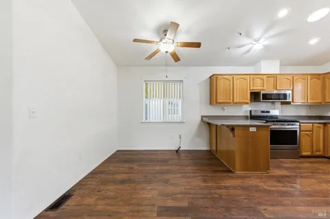 a kitchen with granite countertop a stove cabinets and window
