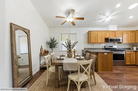 a view of a dining room with furniture and wooden floor