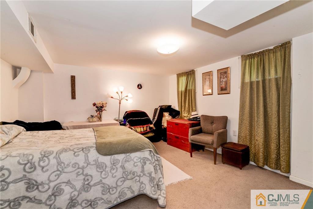 17 Wilk Road Edison, NJ 08837 - Photo 16 of 22 a bedroom with bed couch and window