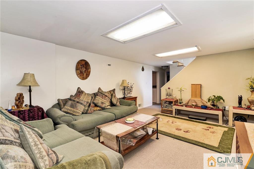 17 Wilk Road Edison, NJ 08837 - Photo 17 of 22 a living room with furniture and a chandelier