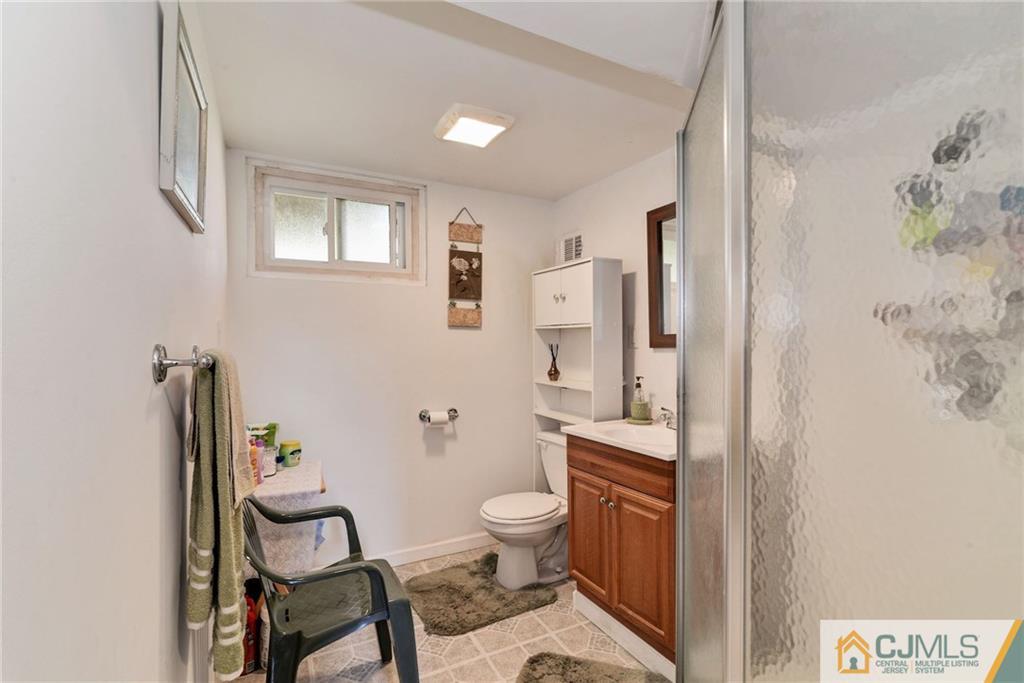 17 Wilk Road Edison, NJ 08837 - Photo 18 of 22 a bathroom with a toilet a sink and a mirror