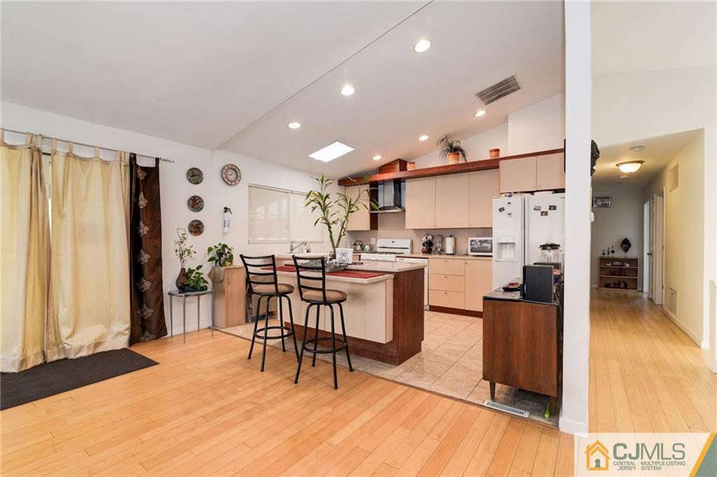 17 Wilk Road Edison, NJ 08837 - Photo 8 of 22 a kitchen with stainless steel appliances kitchen island granite countertop a refrigerator and a sink