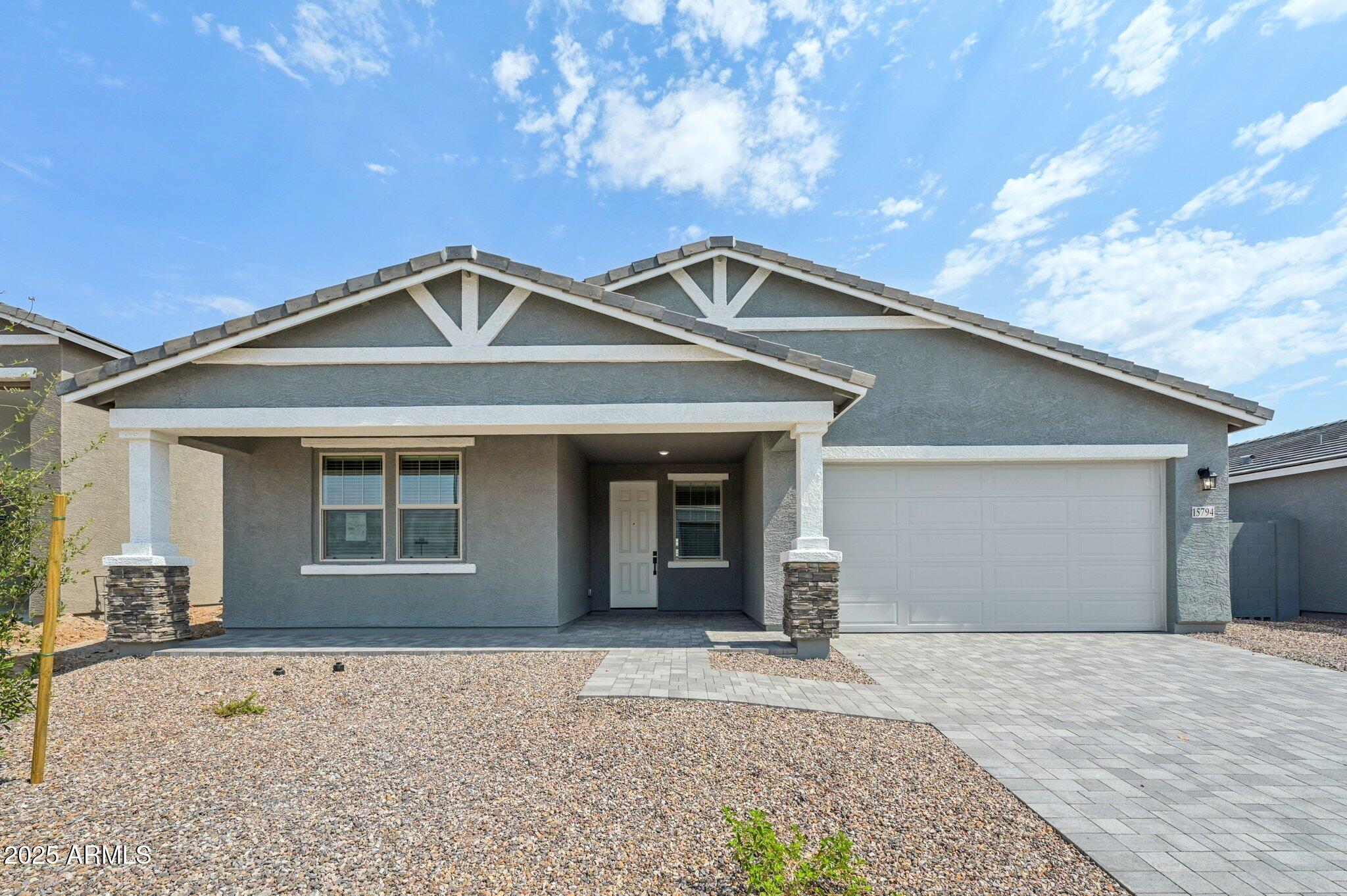 15794 West Cheryl Drive Waddell, AZ 85355 - Photo 1 of 53 a front view of a house with a yard and garage