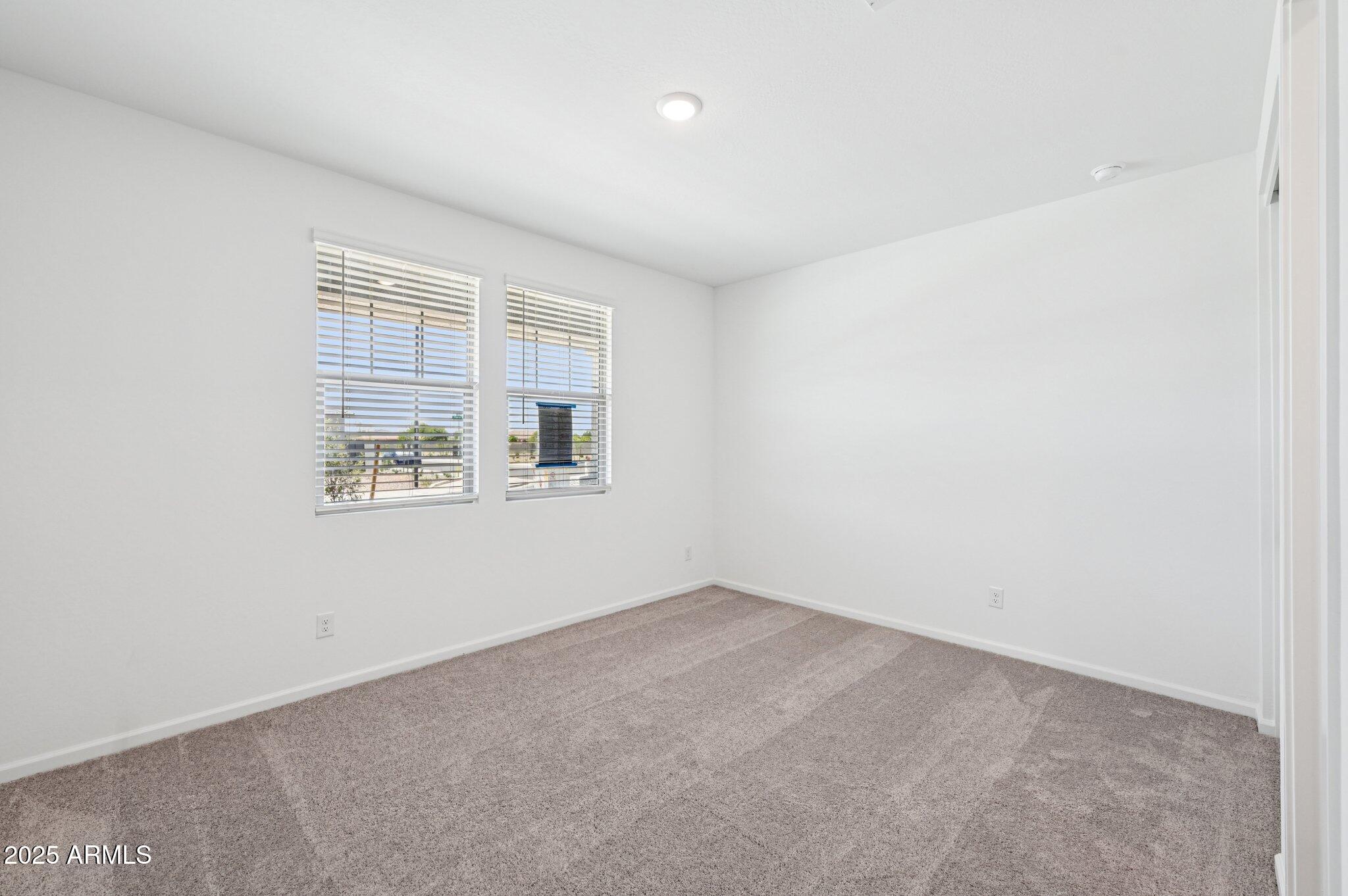 15794 West Cheryl Drive Waddell, AZ 85355 - Photo 12 of 53 an empty room with windows