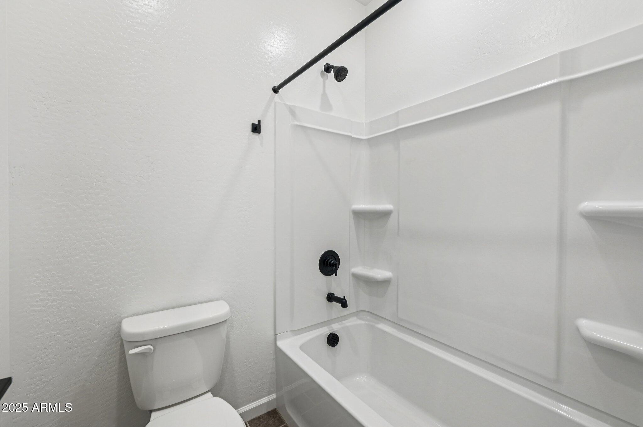 15794 West Cheryl Drive Waddell, AZ 85355 - Photo 14 of 53 a bathroom with a bathtub and toilet