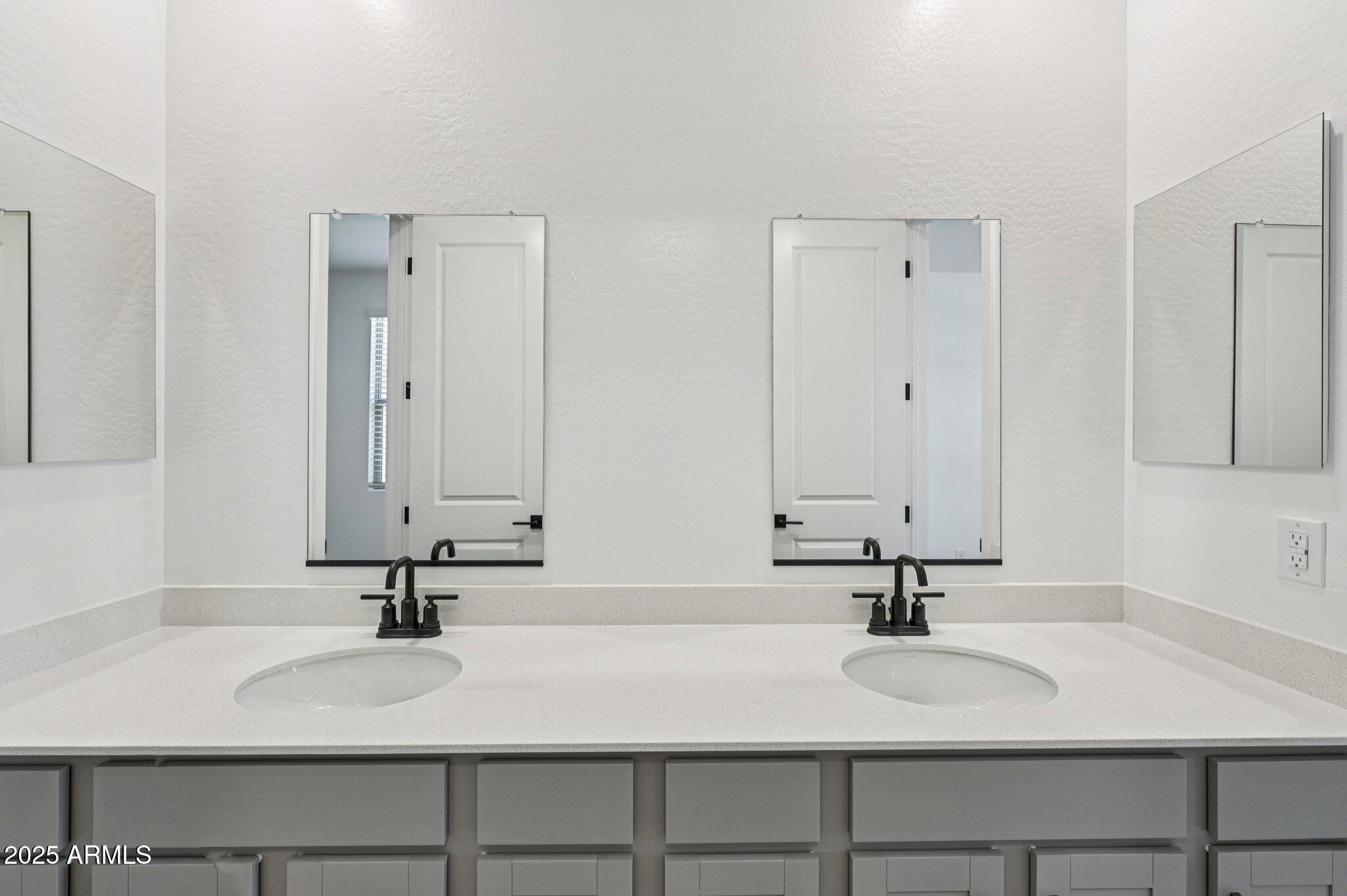15794 West Cheryl Drive Waddell, AZ 85355 - Photo 15 of 53 a bathroom with a sink and a mirror