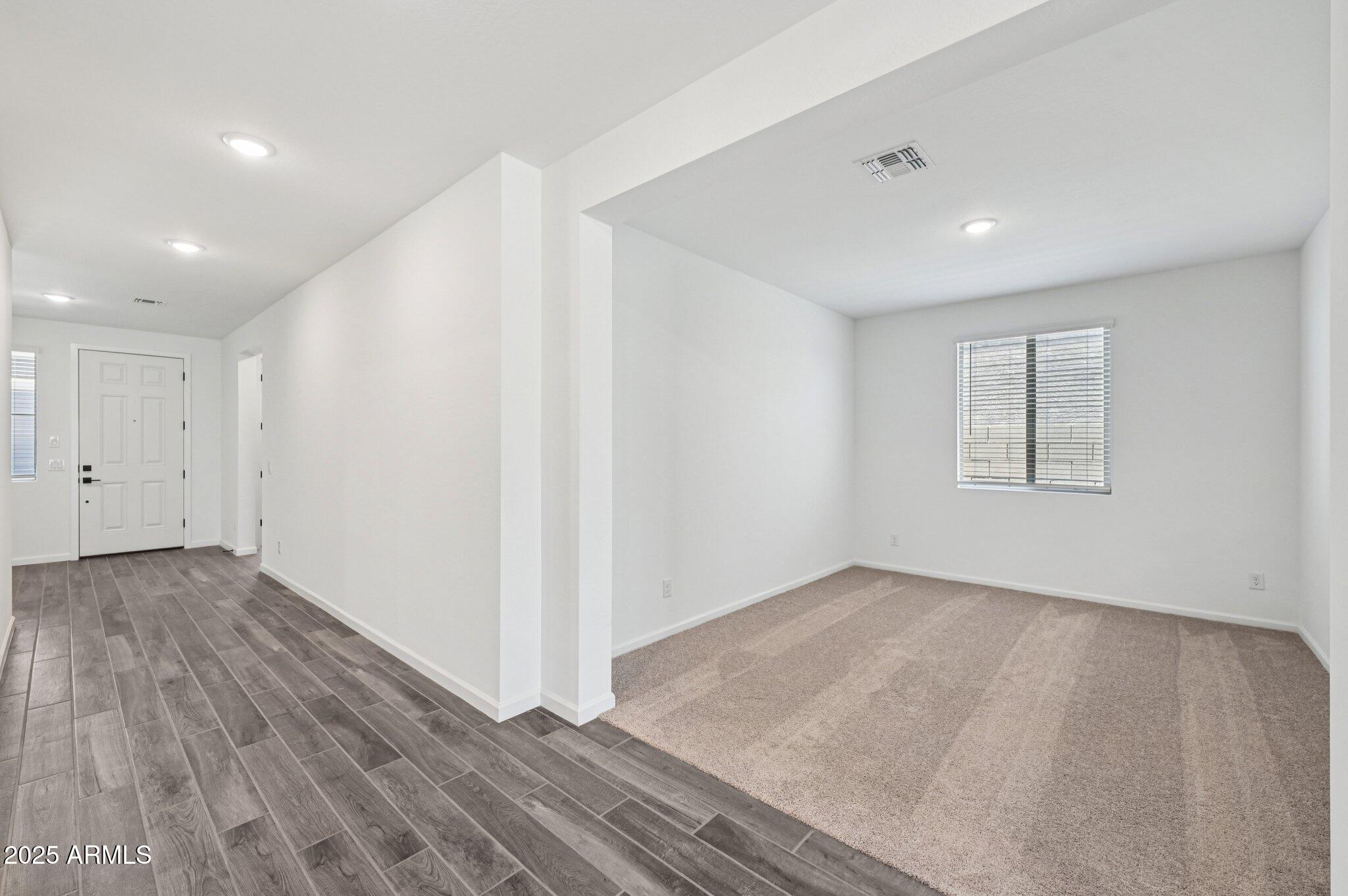 15794 West Cheryl Drive Waddell, AZ 85355 - Photo 21 of 53 an empty room with wooden floor and windows