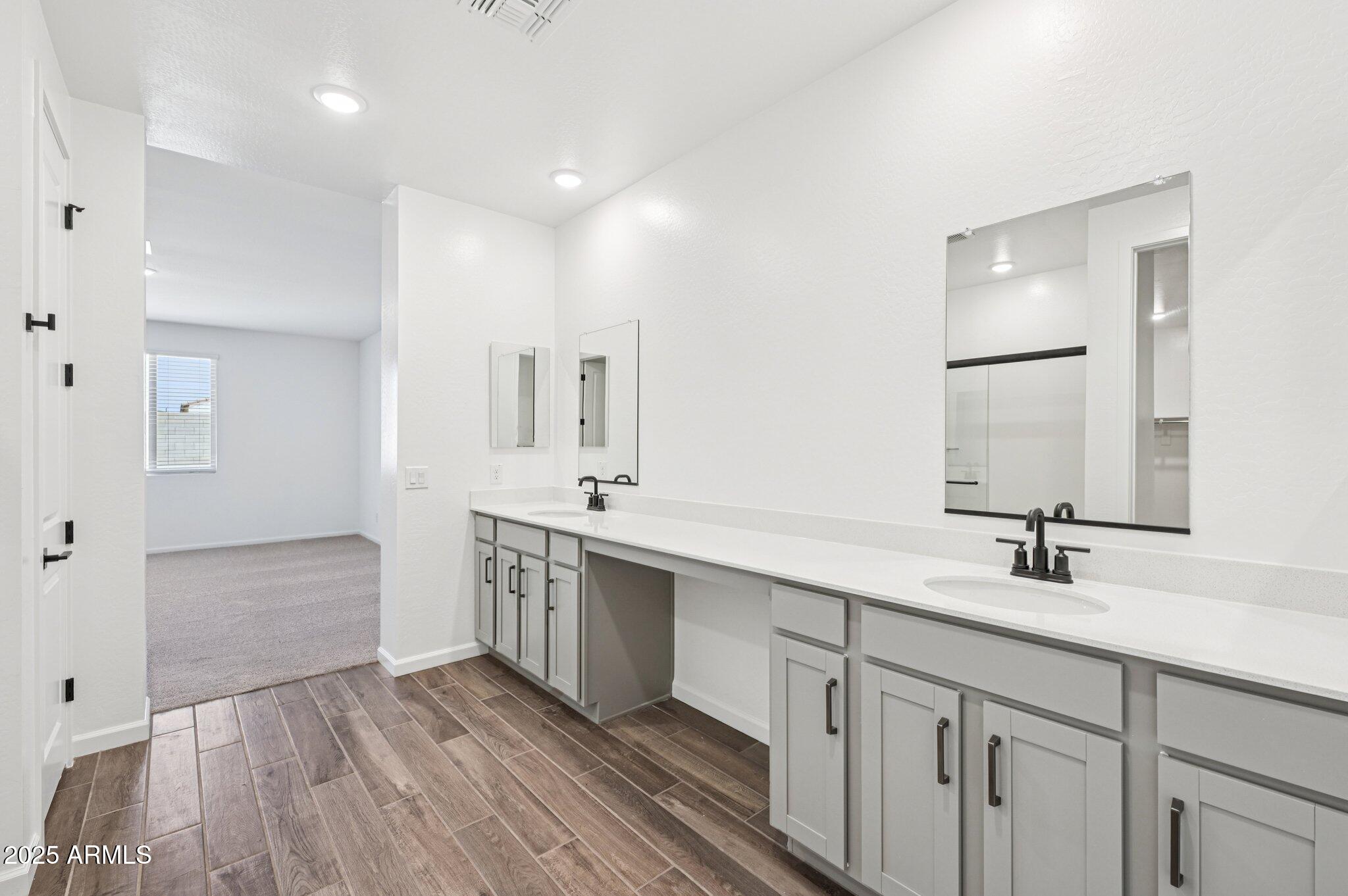 15794 West Cheryl Drive Waddell, AZ 85355 - Photo 25 of 53 a bathroom with a sink a mirror and a shower