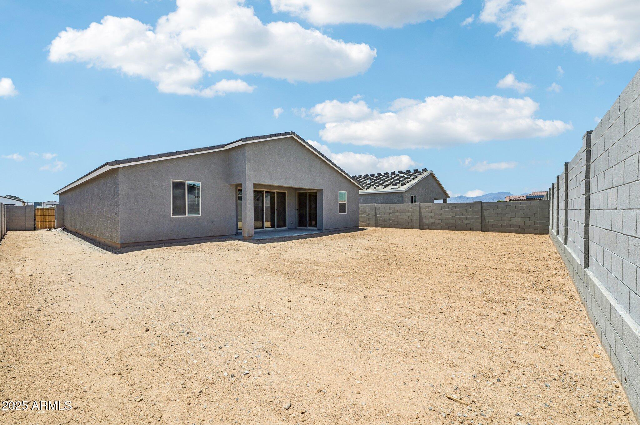 15794 West Cheryl Drive Waddell, AZ 85355 - Photo 34 of 53 a view of empty room with wooden floor and fence