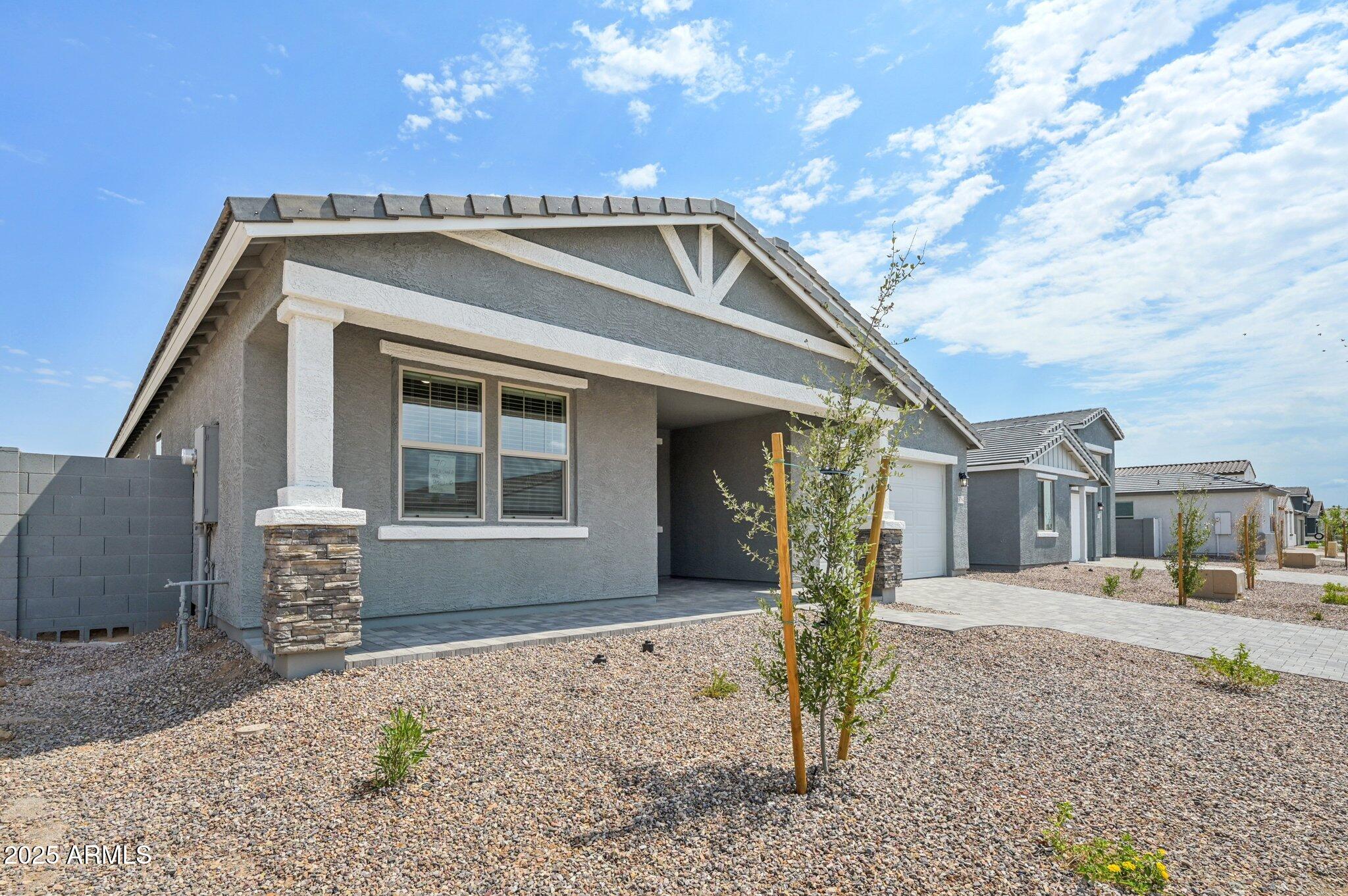 15794 West Cheryl Drive Waddell, AZ 85355 - Photo 35 of 53 a front view of a house with garden