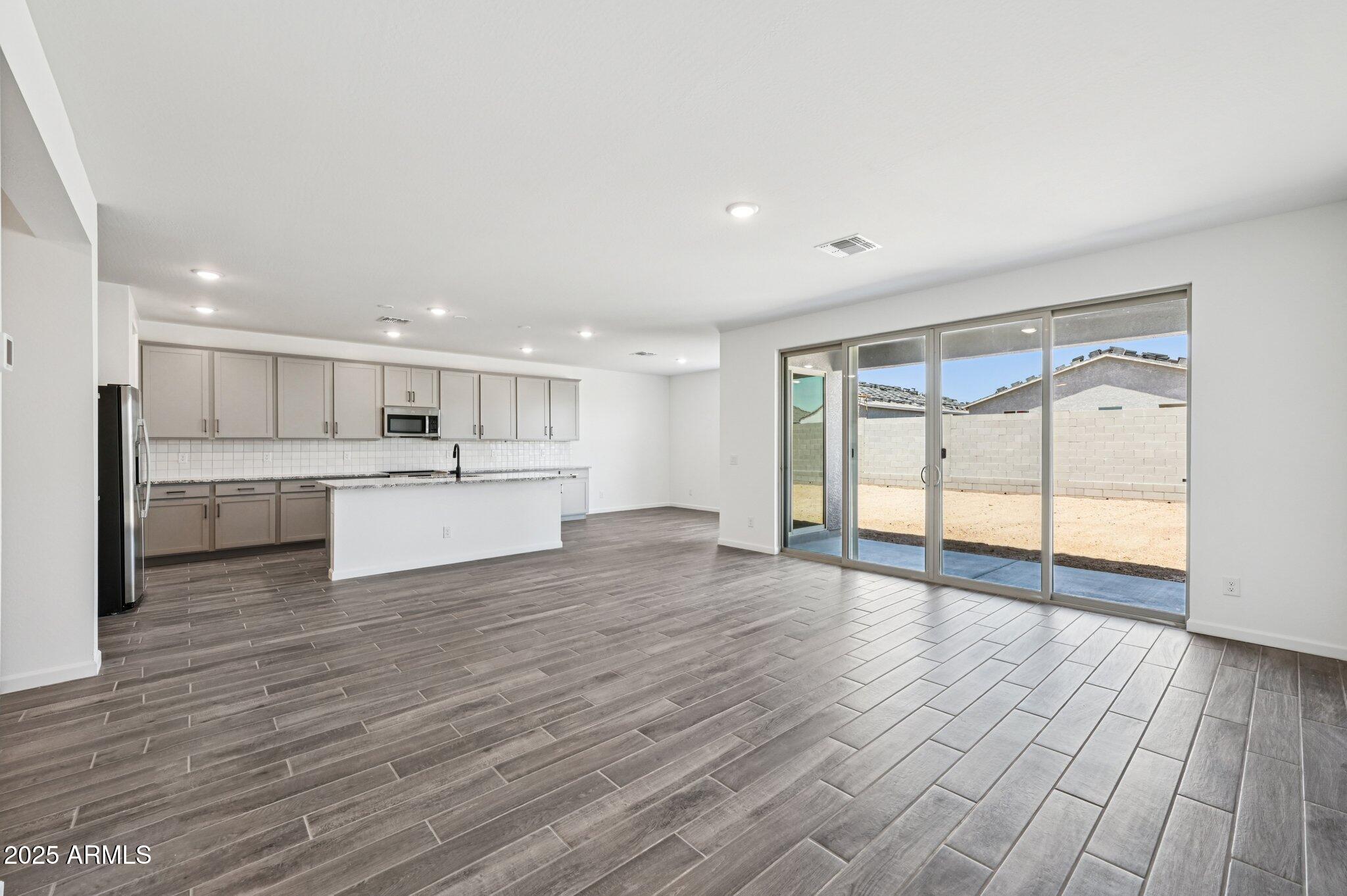 15794 West Cheryl Drive Waddell, AZ 85355 - Photo 4 of 53 a view of kitchen with wooden floor and windows