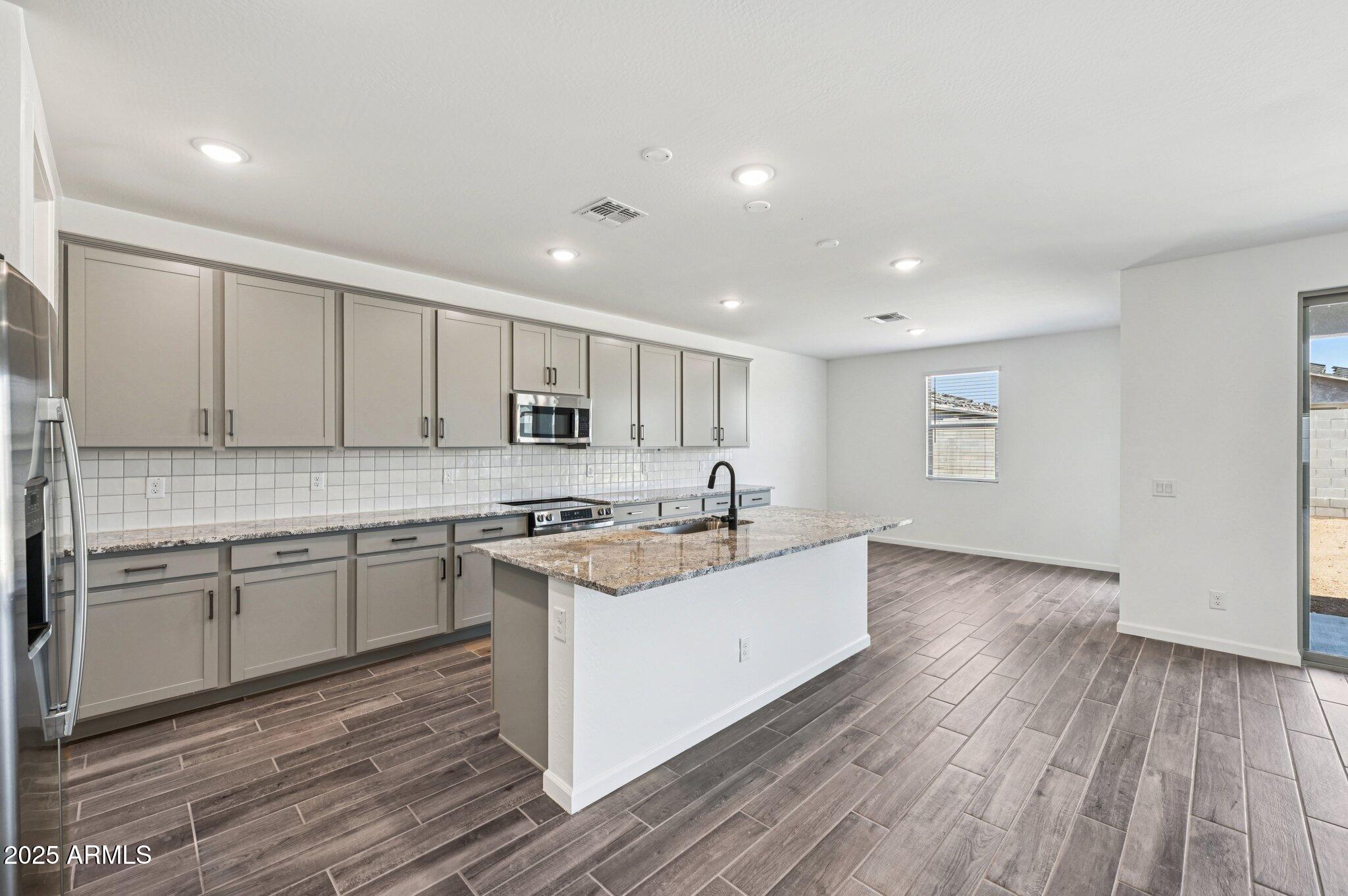 15794 West Cheryl Drive Waddell, AZ 85355 - Photo 8 of 53 a kitchen with a sink stove and cabinets