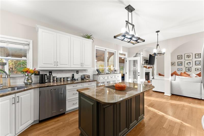 385 Graves Road Acworth, GA 30101 - Photo 15 of 61 a kitchen with kitchen island granite countertop a sink refrigerator and cabinets