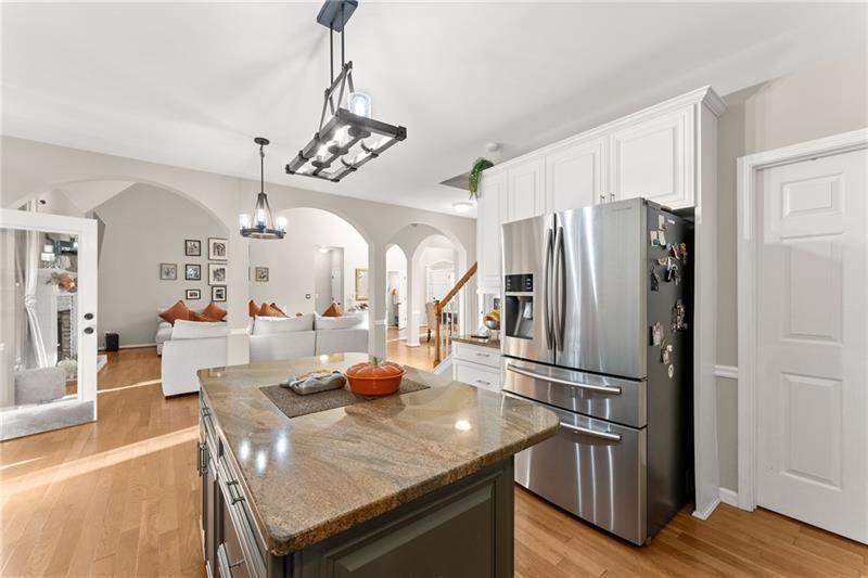 385 Graves Road Acworth, GA 30101 - Photo 16 of 61 a kitchen with stainless steel appliances granite countertop a refrigerator a sink dishwasher a dining table and chairs with wooden floor