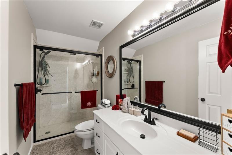 385 Graves Road Acworth, GA 30101 - Photo 26 of 61 a bathroom with a sink mirror toilet and shower