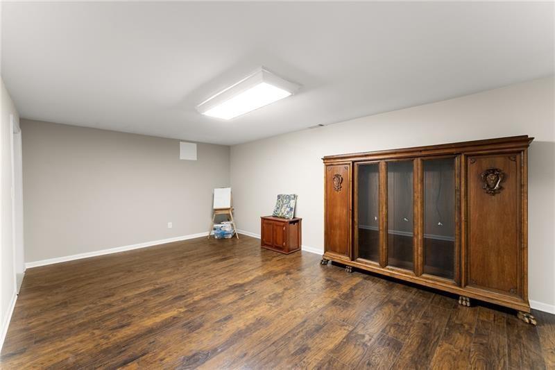 385 Graves Road Acworth, GA 30101 - Photo 31 of 61 an empty room with wooden floor and windows