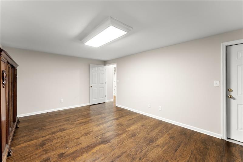 385 Graves Road Acworth, GA 30101 - Photo 32 of 61 an empty room with wooden floor and windows