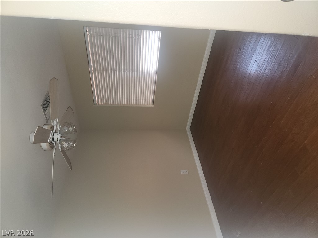 564 Ridgeway Road Henderson, NV 89015 - Photo 16 of 22 Hardwood flooring pairs with an overhead fan, ensuring comfort and elegance in this room.