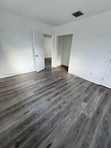 an empty room with wooden floor