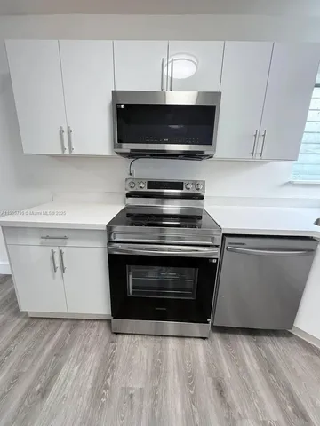 a stove top oven sitting inside of a kitchen