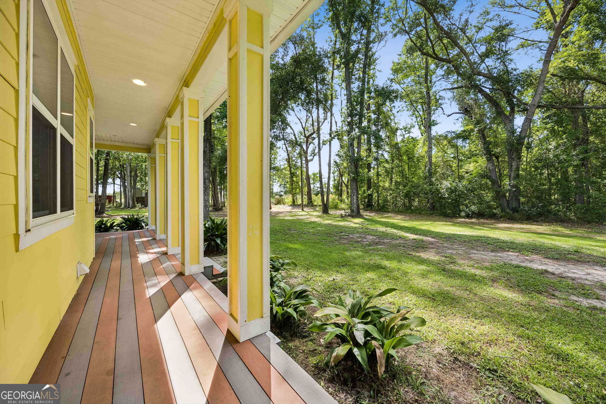 706 Hopewell Point Road White Oak, GA 31568 - Photo 68 of 84 Designed for outdoor enjoyment, the porch extends along the home's exterior and provides easy access to the surrounding yard and grounds.