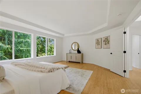 a spacious bedroom with a bed and a window