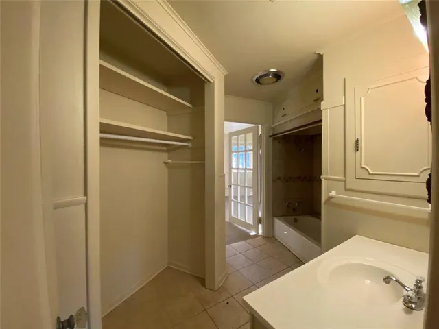 a bathroom with a tub and shower