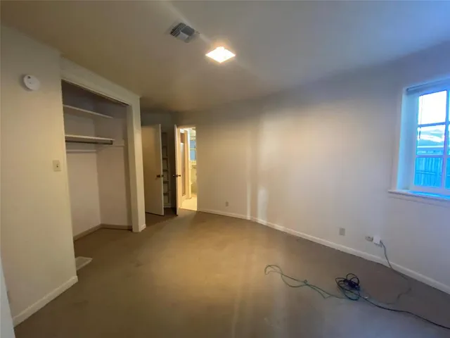 an empty room with closet area