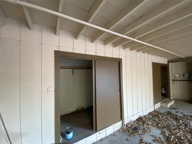 a backyard of a house with portable table and chairs