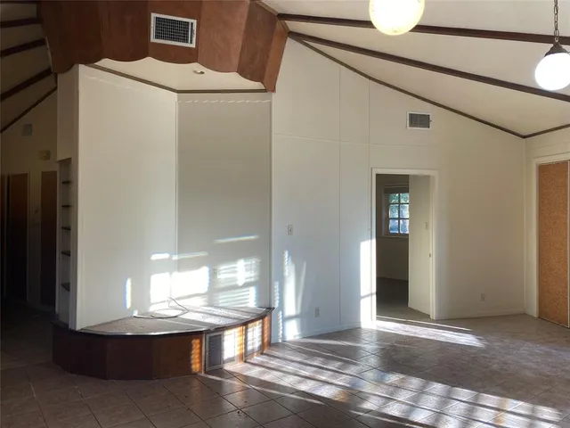 a view of kitchen and hall with wooden floor