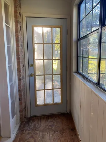 an empty room with large windows