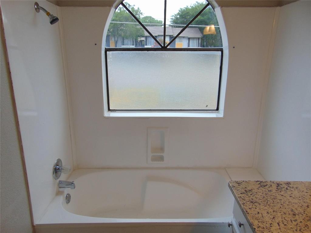 6108 Abrams Road, Unit 311 Dallas, TX 75231 - Photo 13 of 14 a bathroom with a tub and window