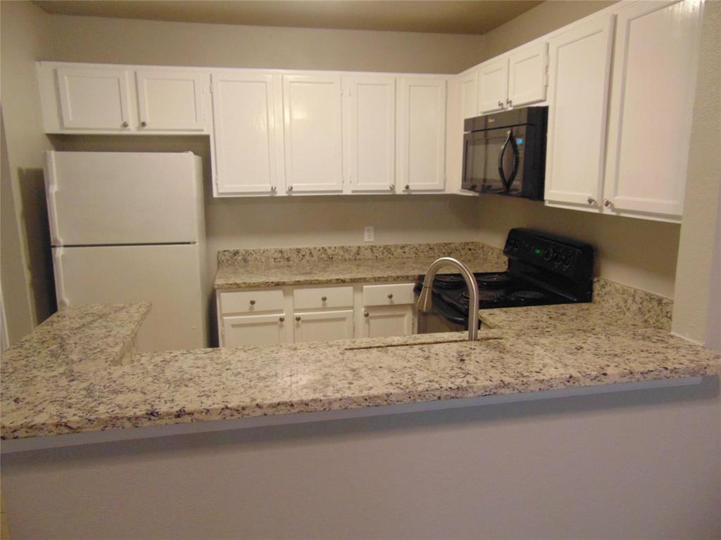 6108 Abrams Road, Unit 311 Dallas, TX 75231 - Photo 3 of 14 a kitchen with granite countertop a sink and a stove