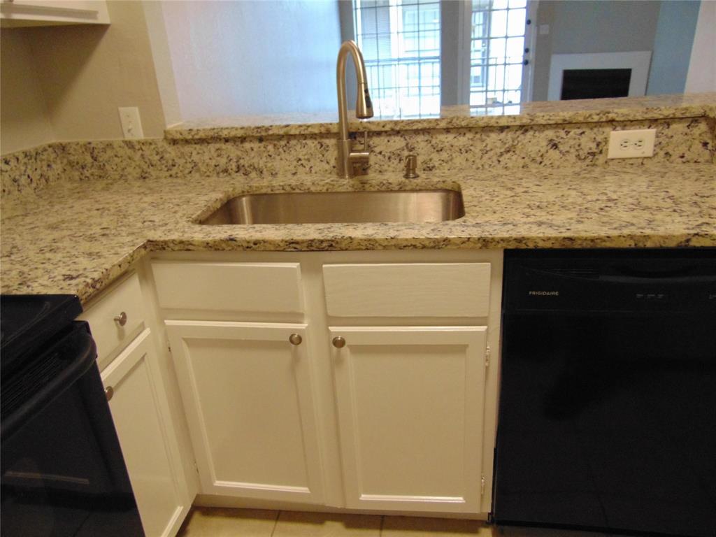 6108 Abrams Road, Unit 311 Dallas, TX 75231 - Photo 8 of 14 a bathroom with a sink and a mirror