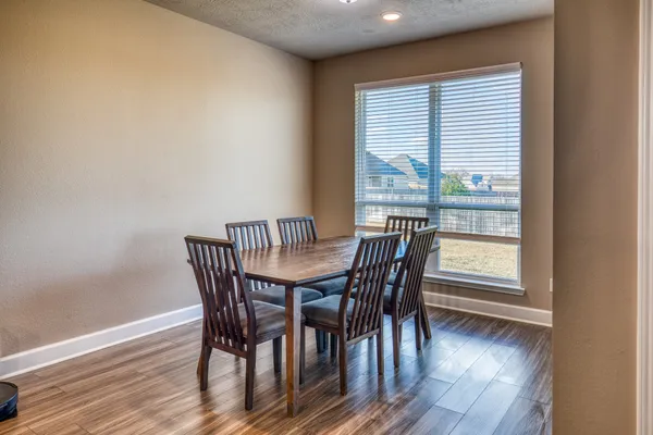 a view of a dining room with furniture and wooden floor