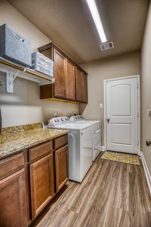 a kitchen with granite countertop a stove and cabinets