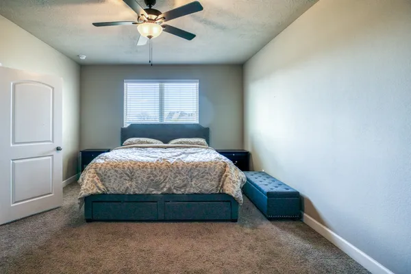 a bedroom with a bed and window