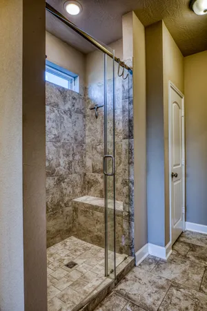 a bathroom with a shower and a mirror