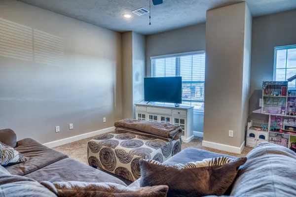 a bedroom with furniture and a flat screen tv