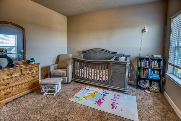 a bedroom with furniture and a book shelf