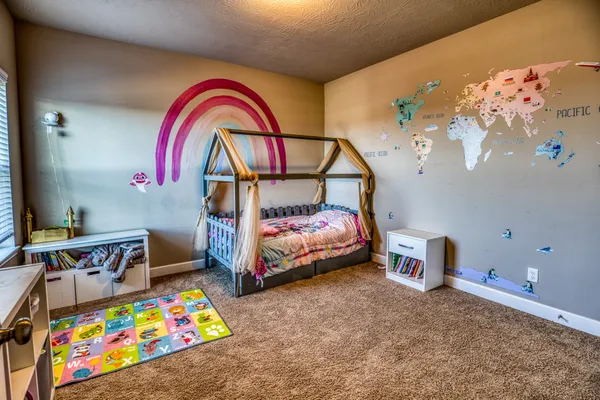 a bedroom with bed and a chandelier